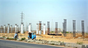Labourers busy in construction work of flyover at Korangi River during development work in Provincial Capital.