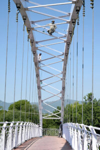 CDA workers diligently apply fresh coats of paint on the bridge while decorating the city for the upcoming 23rd Shanghai Cooperation Organization (SCO) summit in the Federal Capital.