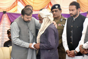Chief Minister Balochistan Sarfraz Bugti is giving cheques to the family members of laborers killed in terrorist attack in Balochistan at Shuja Abad