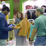 A foreign delegate shows keen interest in leather products during the second day of the 5th International Textile and Leather Exhibition (TEXPO 2024) at the Expo Center in provincial capital