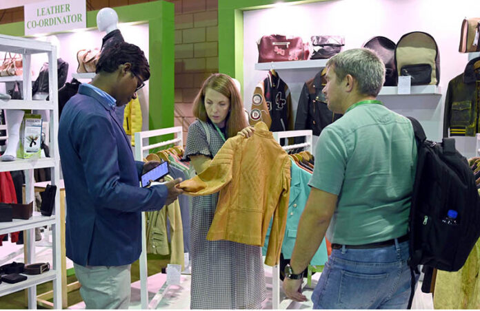 A foreign delegate shows keen interest in leather products during the second day of the 5th International Textile and Leather Exhibition (TEXPO 2024) at the Expo Center in provincial capital