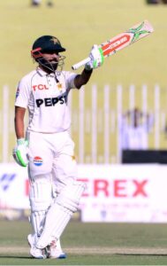 Pakistan player Saud Shakeel celebrates after scoring a century (100 runs) during the second day and last cricket Test match between Pakistan and England Pindi Cricket Stadium in twin cities