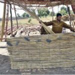 A man crafts traditional bamboo chicks at his workplace in the city