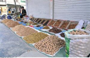 A vendor displaying dry fruit to attract the customers at Dairy Road as demand increased during winter season.
