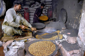 A worker roasting grams at his workplace in the city.