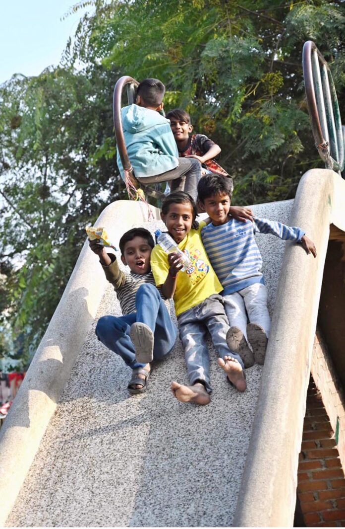 Children enjoy on slide in a local park in Federal Capital