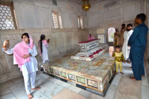 Students visiting the mausoleum of the late Allama Muhammad Iqbal, a renowned Muslim poet and philosopher, capturing selfies and preserving memorable moments with their mobile cameras.