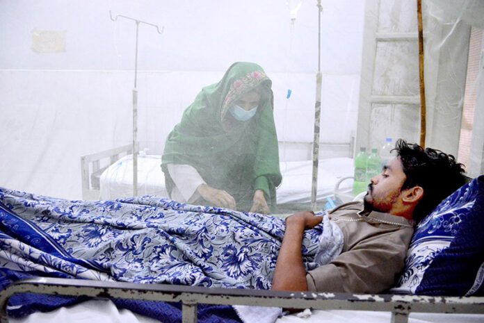 Dengue patients receive treatment in a ward at Bhitai Hospital as the Pakistan Meteorological Department warns of a 'critical' two weeks ahead due to a surge in infections across the country