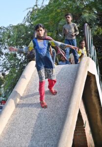 Children enjoy on slide in a local park in Federal Capital