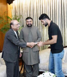 President Asif Ali Zardari presenting a cheque of Rs. 100 million to Shahzaib Khan, who won World Champion Karate Combat in Singapore at Aiwan-e-Sadr. The Chief Minister of Balochistan Mir Sarfraz Bugti was also present on the occasion.