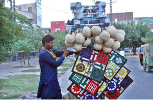 A street vender displaying the traditional game of Ludo and Bird's Nest on his bicycle for sells near Kalma Chowk in the provincial capital.