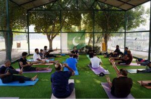 Participants practice yoga at the PHA Yoga Center in Race Course Park, embracing peace and wellness.