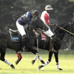 Players fiercely struggle to gain control of the ball during the polo match between Newage Cables and Olympia Polo Team in the Polo in Pink Cup 2024 at Lahore Polo Club