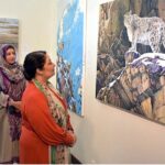 Coordinator to Prime Minister on Climate Change, Romina Khurshid Alam looking at a painting of snow leopard in its natural habitat displayed at the Wildlife Art Exhibition at PNCA in Federal Capital