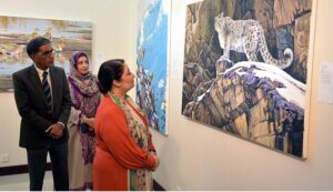 Coordinator to Prime Minister on Climate Change, Romina Khurshid Alam looking at a painting of snow leopard in its natural habitat displayed at the Wildlife Art Exhibition at PNCA in Federal Capital