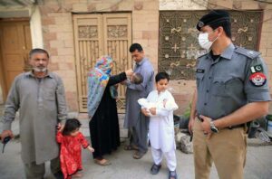 A female polio health worker administers polio drops to a child in a school during the anti-polio vaccination campaign aimed at eradicating polio in the provincial capital.