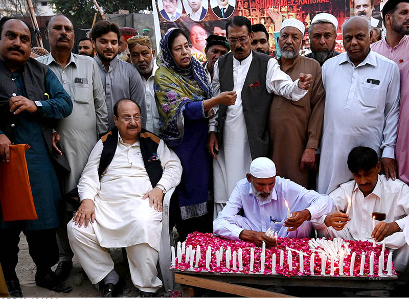 Workers of the People's Party light candles in tribute to the martyrs