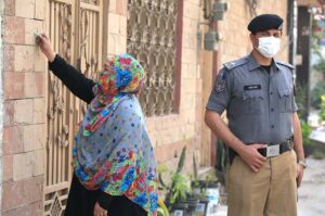 A female polio health worker administers polio drops to a child in a school during the anti-polio vaccination campaign aimed at eradicating polio in the provincial capital.