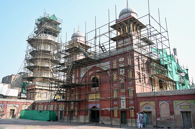 Labourers busy in renovation work to the historical Mosque Masjid Wazir ...