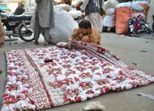 Workers diligently sewing traditional handmade quilts (polyester comforters) by hand. These affordable and lightweight quilts are in increasing demand as temperatures continue to drop in Quetta each passing day