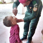 A worker of Rescue 1122 is administering polio drops to children in different areas of the provincial capital for polio prevention campaign in Pakistan