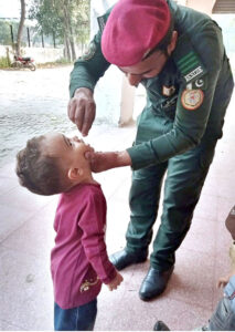 A worker of Rescue 1122 is administering polio drops to children in different areas of the provincial capital for polio prevention campaign in Pakistan