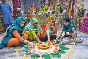 Hindu community women lit-up the earth lamps at old Durga Shiv Mandir in connection with Diwali festival
