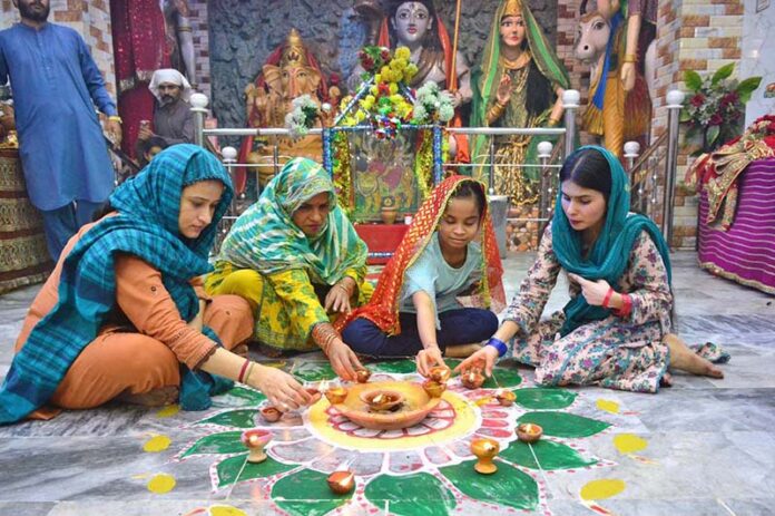 Hindu community women lit-up the earth lamps at old Durga Shiv Mandir in connection with Diwali festival