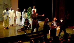 Artists performing theatre play Slaver: Aaj Ki Taza Khabar- dark comedy, directed by Younas Khan and written by Nasir Saleem during the 7th day of the World Culture Festival Karachi 2024 at Arts Council of Pakistan Karachi.