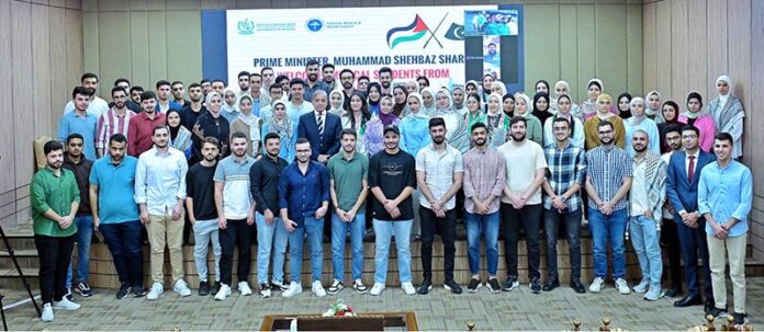 Prime Minister Muhammad Shehbaz Sharif in a group photo with students of Palestine who recently arrived in Pakistan to complete their medical education