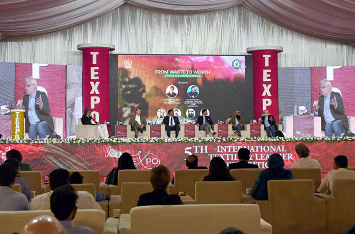 CEO Pakistan Textile Council, Sheikh Muhammad Iqbal speaks during the Seminar from Waste to Worth Curricular Innovations in Pakistan second day of the 5th International Textile and Leather Exhibition TEXPO 2024. Mr. Boudewijn Mol Director M/S Bedding House, Mr Usman Khan Investment Trade and Climate Finance Advisor REMIT and others also seen on the stage
