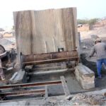 Labourer busy in preparing cement sewege pipe at their workplace