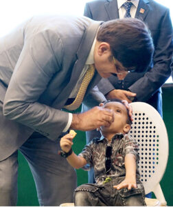 Sindh Chief Minister, Syed Murad Ali Shan administers Polio drops to a child in observance of world Polio Day