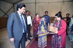 Minister of State for Information Technology and Telecommunication of Pakistan, Shaza Fatima along with Sindh Governor Kamran Tessori distributing Rashan bags among the deserving people