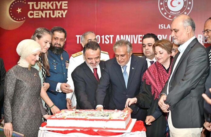 Deputy Prime Minister and Foreign Minister Senator Mohammad Ishaq Dar cutting cake during a ceremony to mark 101st Anniversary of Turkish Republic Day
