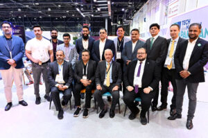Ambassador Faisal Niaz Tirmizi, Pakistan’s Envoy in UAE along with visiting delegates from Pakistan and local students visitors standing in front of monument highlighting “Tech Destination Pakistan 2024” displayed at Dubai World Trade Centre.
