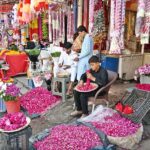 Vendors busy making flower garlands and displaying flower bouquet to attract the customers at Banni Chowk