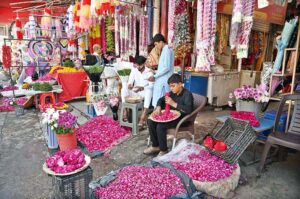 Vendors busy making flower garlands and displaying flower bouquet to attract the customers at Banni Chowk