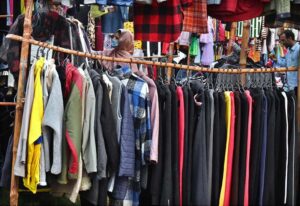 People are selecting and purchasing second-hand warm clothes from Landa Bazaar at Zia Masjid Stop along Express Highway