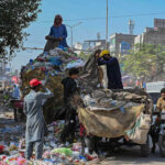 Gypsy men searching valuables from garbage dump at Khanna Pul