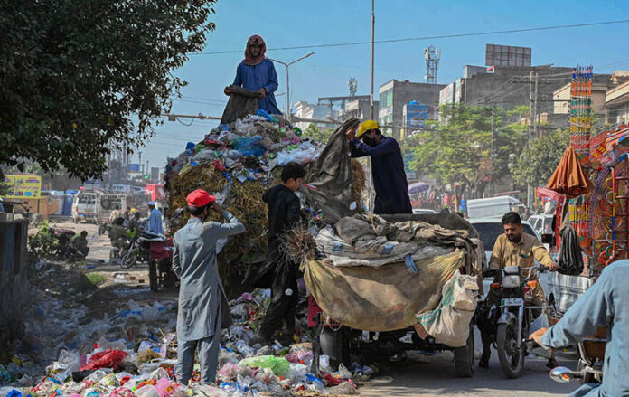 Gypsy men searching valuables from garbage dump at Khanna Pul