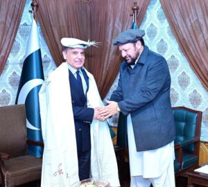 Chief Minister Gilgit-Baltistan Gulbar Khan presents traditional Balti robes and a cap to Prime Minister Muhammad Shehbaz Sharif.