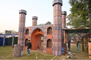 Workers are busy in installation a model of the provincial major cities for the upcoming Folk Festival "Lok Mela 2024" at Lok Versa in the Federal Capital.