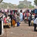 People are selecting and purchasing second-hand warm clothes from Landa Bazaar at Zia Masjid Stop along Express Highway