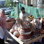 A vendor selling household items to attract customers at roadside