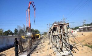 Labourers are busy in construction work of flyover at under construction 10th Avenue during development work in Federal Capital.