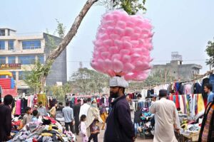 People are selecting and purchasing second-hand warm clothes from Landa Bazaar at Zia Masjid Stop along Express Highway