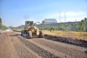 Labourers busy in construction work of bridge at service road along Karnal Sher Khan Shaheed Road during development work in the city.