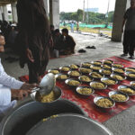 Volunteers distribute free food among poor people and daily wage laborers at Ghouri town Vip block