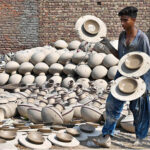 A worker arranging clay-made stuff for drying purpose at his workplace in Kumharpara at Jamshoro Road